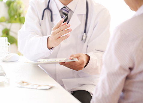 A doctor is holding his hand out to someone