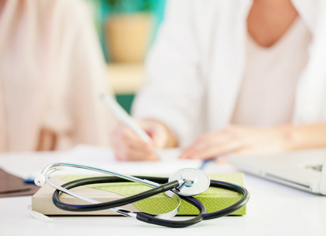 A stethoscope is sitting on top of a book.